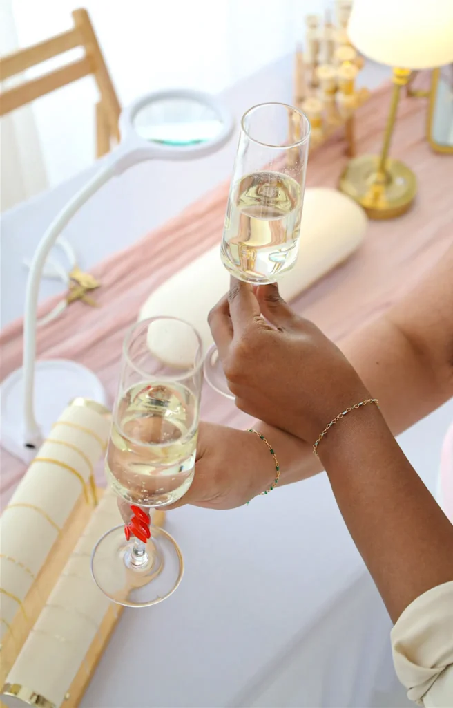 Two people clinking champagne glasses celebrating.