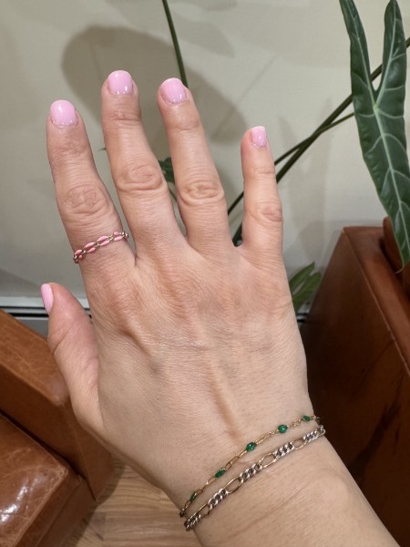 Hand with pink nails and bracelets