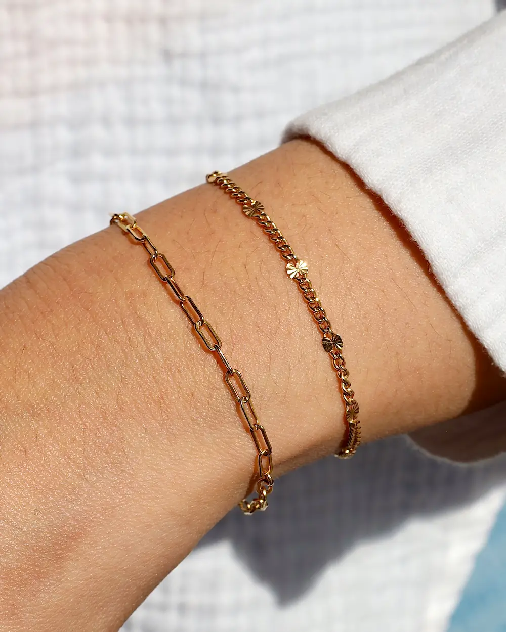 Gold bracelets on wrist close-up