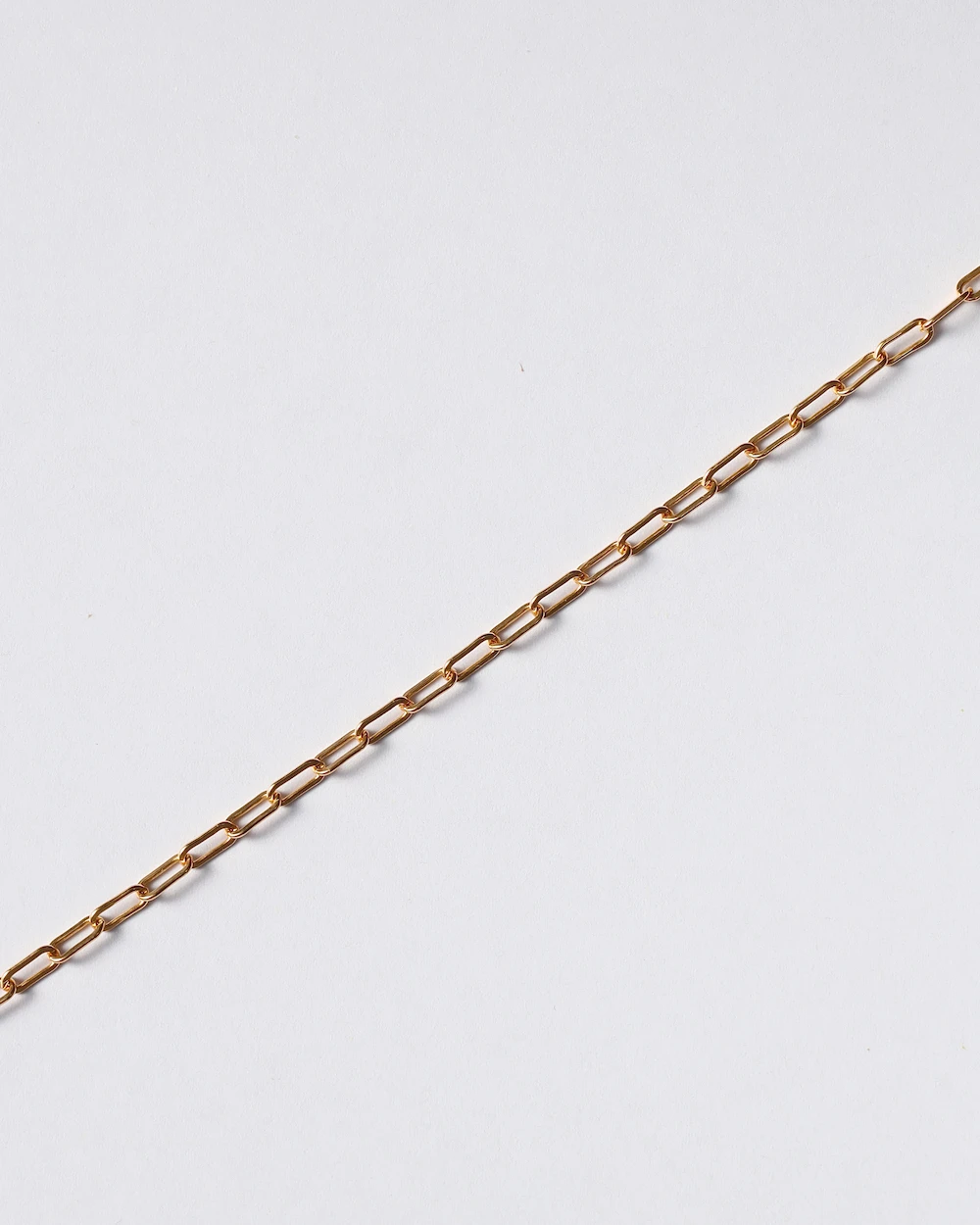 Gold chain necklace on white background