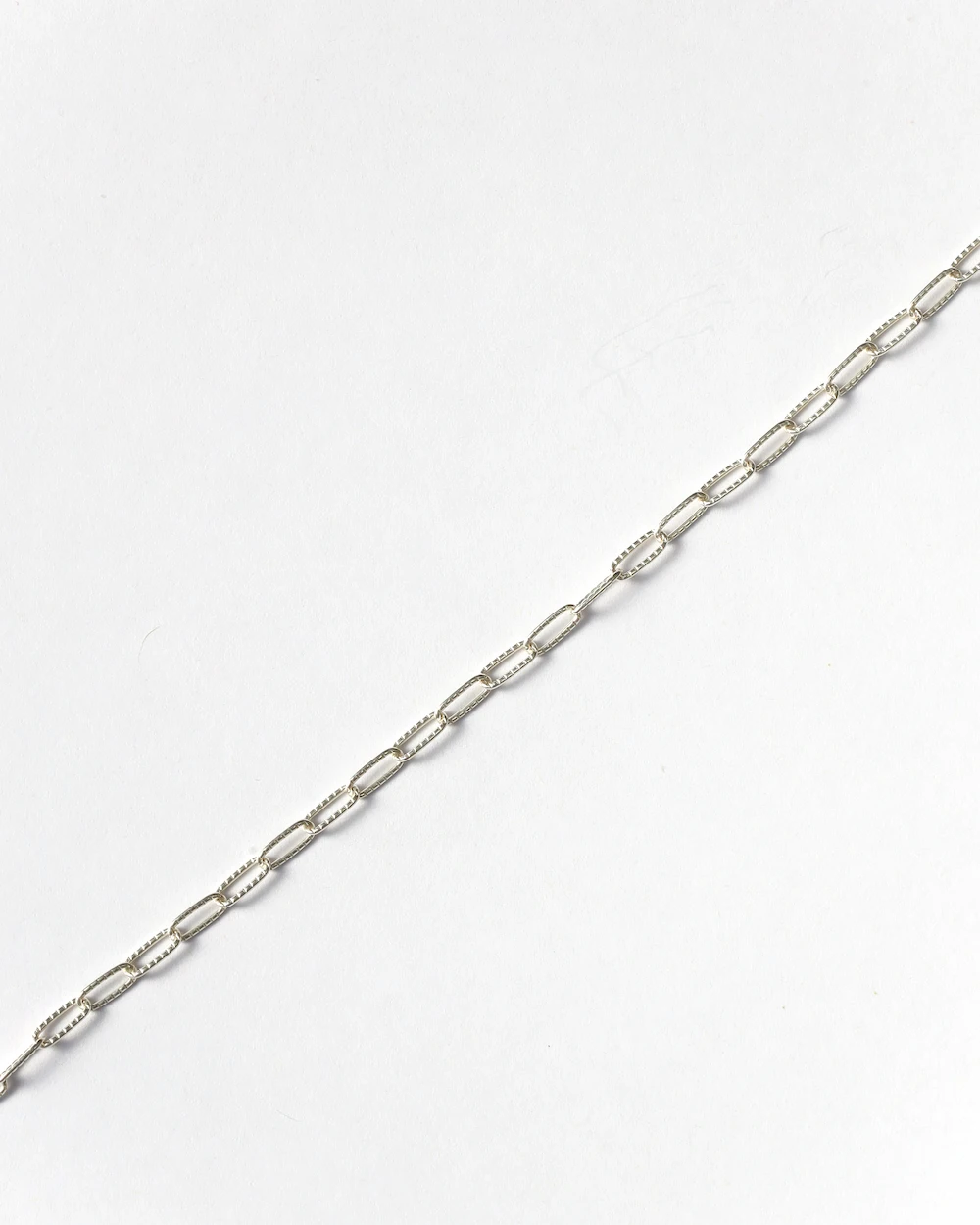 Silver chain necklace on white background